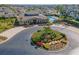 Stunning aerial view of the community clubhouse with a circular driveway and lush landscaping at 17437 Promenade Dr, Clermont, FL 34711