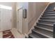 Inviting entryway with tiled floors, stairs, and a decorative sign at 17437 Promenade Dr, Clermont, FL 34711