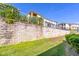 Well-maintained exterior with sturdy retaining wall and manicured landscaping at 17437 Promenade Dr, Clermont, FL 34711