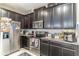 Close up of the kitchen with stainless steel appliances and dark cabinetry at 17437 Promenade Dr, Clermont, FL 34711