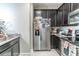 Galley kitchen featuring stainless steel refrigerator, stove, and granite counters at 17437 Promenade Dr, Clermont, FL 34711