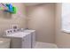 This laundry room boasts a wire shelf and washer and dryer at 17437 Promenade Dr, Clermont, FL 34711