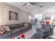 Living room featuring gray sectional, modern art, open plan and comfortable decor at 17437 Promenade Dr, Clermont, FL 34711