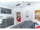 Main bedroom with a TV, ceiling fan, and view into an adjacent living space at 17437 Promenade Dr, Clermont, FL 34711