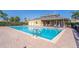 Sparkling community pool surrounded by lounge chairs and well-maintained brick pavers at 17437 Promenade Dr, Clermont, FL 34711