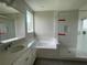 Relaxing bathroom features a soaking tub, walk-in shower, and double vanity at 17505 Glossy Pomelo Way, Winter Garden, FL 34787