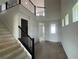 Elegant foyer showcases soaring ceilings, wood floors, and an open staircase at 17505 Glossy Pomelo Way, Winter Garden, FL 34787