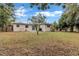 Backyard view of a home with a small patio and a grassy area at 1810 Kingsland Ave, Orlando, FL 32808