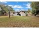 Spacious backyard showing the home's rear elevation and grassy area at 1810 Kingsland Ave, Orlando, FL 32808