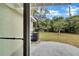 View of backyard from the slider, showing the patio and grassy area at 1810 Kingsland Ave, Orlando, FL 32808