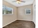 Cozy bedroom with wood-look flooring, neutral walls, and ample natural light at 1810 Kingsland Ave, Orlando, FL 32808