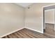 Neutral bedroom with wood-look flooring and a doorway to another room at 1810 Kingsland Ave, Orlando, FL 32808