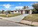 Charming single-story home featuring a red front door and a spacious driveway at 1810 Kingsland Ave, Orlando, FL 32808