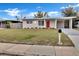 Cozy single-story home boasts a vibrant red front door and well-maintained lawn at 1810 Kingsland Ave, Orlando, FL 32808