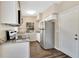 Functional kitchen featuring stainless steel appliances, granite countertops, and dark wood flooring at 1810 Kingsland Ave, Orlando, FL 32808