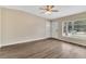 Bright living room featuring wood floors, a ceiling fan, and a sunlit window at 1810 Kingsland Ave, Orlando, FL 32808