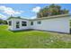 A lush backyard featuring a white house with new windows and a well maintained lawn at 200 Melissa Ct, Sanford, FL 32773