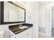 Bathroom featuring a dark wood framed mirror, granite countertop, and white cabinets at 200 Melissa Ct, Sanford, FL 32773