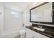 Bright bathroom featuring white cabinets, granite countertop, and a tile shower at 200 Melissa Ct, Sanford, FL 32773