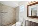 Bathroom with tile shower, decorative tile stripe, and a dark wood vanity at 200 Melissa Ct, Sanford, FL 32773