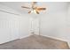 Bedroom with carpet, a ceiling fan, closet and entry way to bathroom at 200 Melissa Ct, Sanford, FL 32773