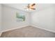 Bedroom with neutral walls and carpet features a ceiling fan and a window at 200 Melissa Ct, Sanford, FL 32773