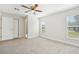 Bedroom with neutral walls and carpet complemented by natural light from two windows at 200 Melissa Ct, Sanford, FL 32773