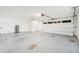 A bright garage with white walls, concrete floor, and large garage door at 200 Melissa Ct, Sanford, FL 32773