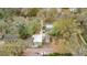 An aerial perspective shows the house and the detached garage. Lush trees offer lots of privacy at 201 W 16Th St, Sanford, FL 32771