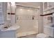 Bright bathroom features a tiled glass shower, vanity, and toilet at 201 W 16Th St, Sanford, FL 32771