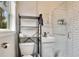 Modern bathroom features subway tile shower, floating vanity, and convenient shelving unit at 201 W 16Th St, Sanford, FL 32771