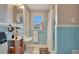 Bathroom featuring blue tile, a sink, a mirror, a window and natural light at 201 W 16Th St, Sanford, FL 32771