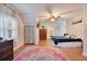 Spacious bedroom featuring hardwood floors, an area rug, a ceiling fan and natural light at 201 W 16Th St, Sanford, FL 32771