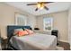 Bright bedroom with a ceiling fan, two windows, and a comfortable-looking bed at 201 W 16Th St, Sanford, FL 32771