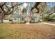 Charming home with lush landscaping, mature trees, and an inviting red front door at 201 W 16Th St, Sanford, FL 32771