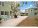 View of the home with a patio, chairs, and detached garage at 201 W 16Th St, Sanford, FL 32771