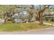 Well-kept home framed by mature trees, featuring a green lawn and corner lot appeal at 201 W 16Th St, Sanford, FL 32771