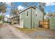 Two story building with a one-car garage is accessed by a gravel driveway at 201 W 16Th St, Sanford, FL 32771