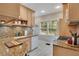 Traditional kitchen with granite countertops, bright cabinets, and a white tile floor at 201 W 16Th St, Sanford, FL 32771