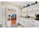 Efficient kitchenette featuring white cabinets, granite countertops, and open shelving at 201 W 16Th St, Sanford, FL 32771