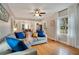 Bright living room with hardwood floors, a large window and a doorway to the dining area at 201 W 16Th St, Sanford, FL 32771