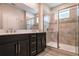 Modern bathroom features a double vanity with a glass-enclosed shower, providing a luxurious and functional space at 210 Wooded Vine Dr, Winter Springs, FL 32708