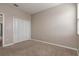 Inviting bedroom with neutral walls and plush carpeting, featuring a closet for storage and a window for natural light at 210 Wooded Vine Dr, Winter Springs, FL 32708