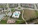 Aerial view of the community pool, playground, parking, and greenspace at 210 Wooded Vine Dr, Winter Springs, FL 32708