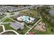 Aerial view of the community pool, playground, parking, and greenspace at 210 Wooded Vine Dr, Winter Springs, FL 32708