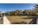 Community dog park featuring separate sections for small and large breeds with benches and palm trees at 210 Wooded Vine Dr, Winter Springs, FL 32708