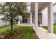 Attractive front yard with a tree and black railings leading to the entrance, enhancing curb appeal and creating a welcoming entrance at 210 Wooded Vine Dr, Winter Springs, FL 32708