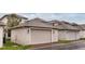 Exterior shot of a garage with a neutral-toned door, showing a clean design and practical space for parking and storage at 210 Wooded Vine Dr, Winter Springs, FL 32708