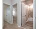 Neutral hallway with a view of a full bathroom and doorway to bedroom, creating a harmonious transition between spaces at 210 Wooded Vine Dr, Winter Springs, FL 32708