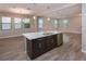 Bright open space featuring a kitchen island with stainless steel dishwasher and a double sink at 210 Wooded Vine Dr, Winter Springs, FL 32708